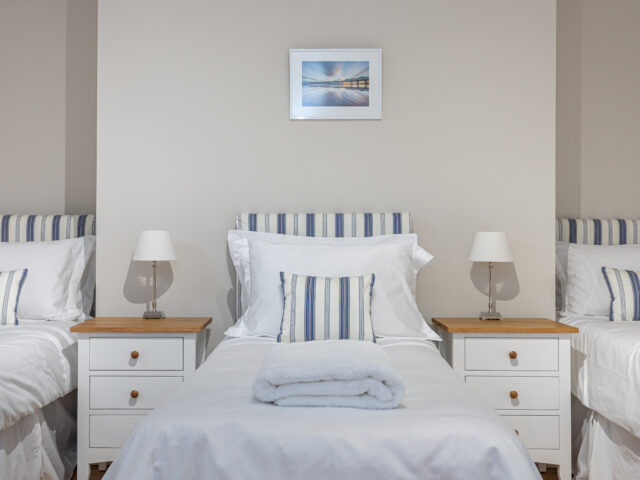 Bedroom with four single beds in the Central Brighton Town House